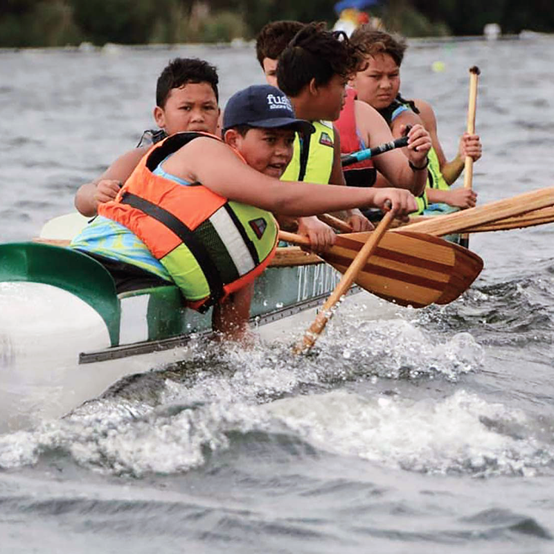 Young people participating in waka ama 500w